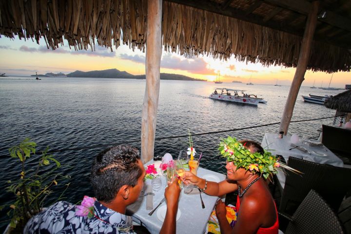 A couple having dinner at St James restaurant in Bora Bora